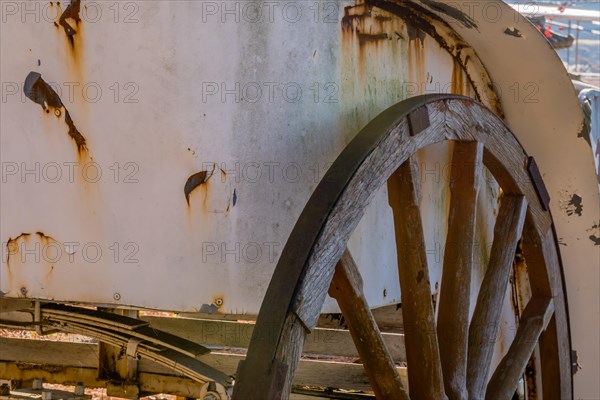 Closeup of antique wooden wheel on old rusted horse drawn carriage in South Korea