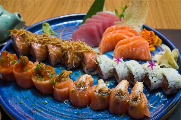 Combined of differents japanese sushi on a elegant blue plate