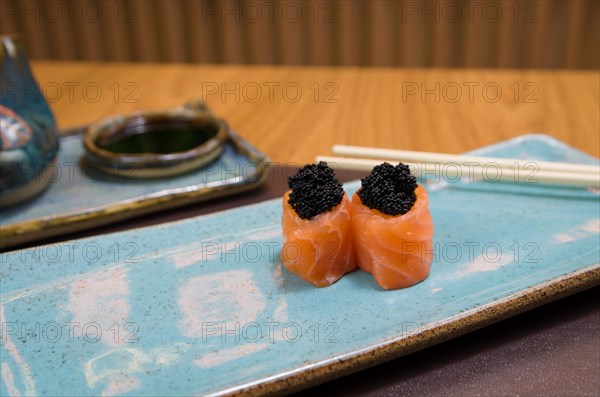 Combined of differents japanese sushi on a elegant blue plate