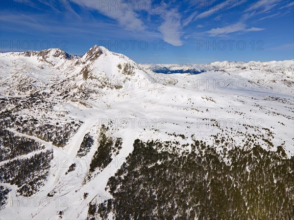 Wide-angle aerial view of snow-covered mountains and forest areas under a blue sky, Grau Roig, Encamp, Andorra, Pyrenees, Europe