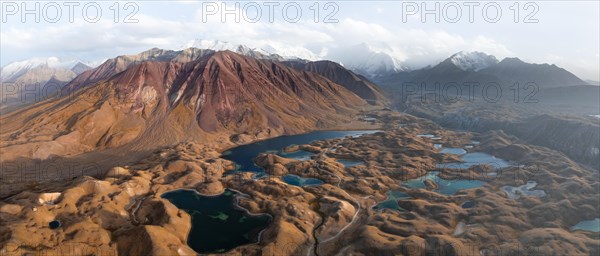 Atmospheric aerial view, high mountain landscape with glacier moraines and mountain lakes, behind Pik Lenin, Trans Alay Mountains, Pamir Mountains, Osher Province, Kyrgyzstan, Asia