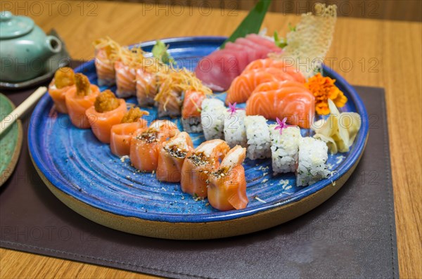 Combined of differents japanese sushi on a elegant blue plate