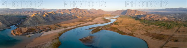 Naryn River between mountains and fields, at Toktogul Reservoir at sunset, aerial view, Kyrgyzstan, Asia