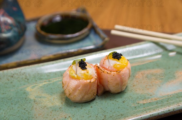 Combined of differents japanese sushi on a elegant blue plate