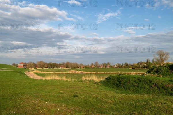 Landscape near Pogum, left pumping station, right houses in the village, municipality Jemgum, district Leer, Rheiderland, East Frisia, Lower Saxony, Germany, Europe