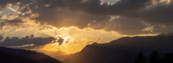 Cloudy mood in front of sunset over a mountain peak, view from the lowlands, panoramic shot, Leoben, Styria, Austria, Europe