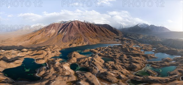 Atmospheric aerial view, high mountain landscape with glacier moraines and mountain lakes, behind Pik Lenin, Trans Alay Mountains, Pamir Mountains, Osher Province, Kyrgyzstan, Asia