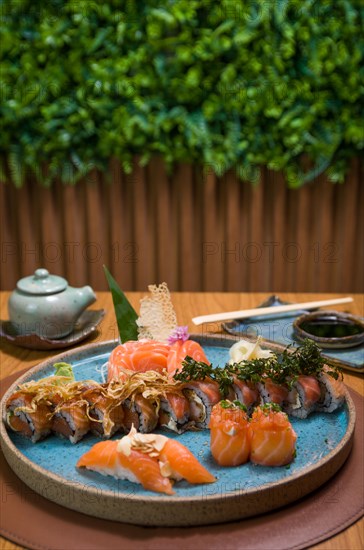 Combined of differents japanese sushi on a elegant blue plate