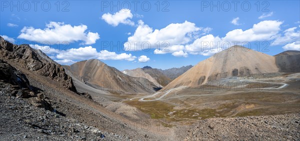 Mountain road through a colourful mountain landscape, view from the Chong Ashuu Pass, Tien Shan, Kyrgyzstan, Asia
