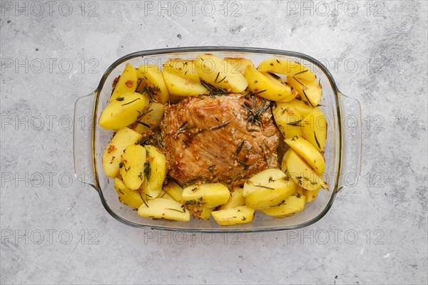 Top view of baked pork fillet with potato wedges