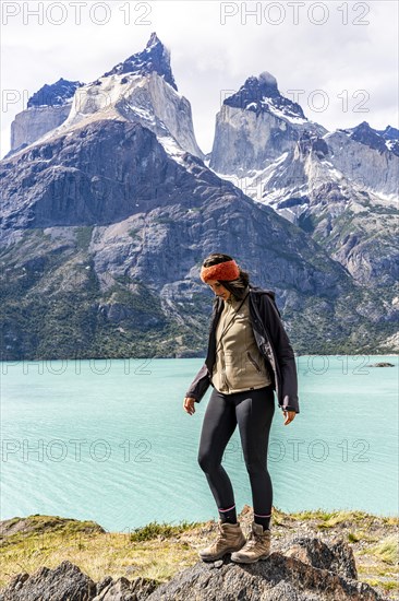 Young woman in front of Nordenskjold Lake and the Paine Mountain Range, Torres de Paine, Magallanes and Chilean Antarctica, Chile, South America