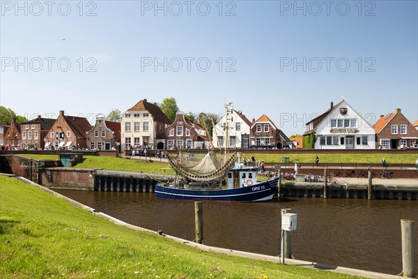 Picturesque cutter harbour, Greetsiel, ebikes, gabled houses, Krummhoern, East Frisia, Germany, Europe