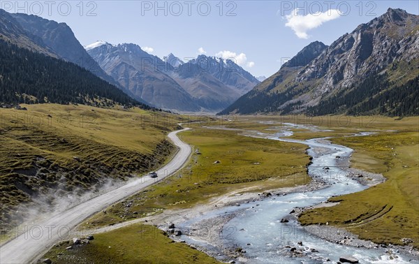 Car on road, mountain river in green mountain valley in the Tien Shan Mountains, Jety Oguz, Kyrgyzstan, Asia