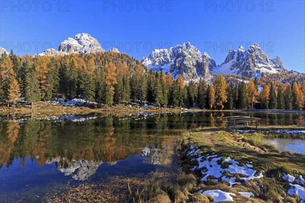 An idyllic lake reflects snow-covered mountains and autumnal trees, Italy, South Tyrol, Belluno, Dolomites, Lago d'Antorno against Cadini, Misurina, Sesto Dolomites, Veneto, Europe