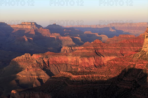 The crimson light of sunset paints the rock formations of the Grand Canyon, Grand Canyon National Park, South Rim, North America, USA, South-West, Arizona, North America