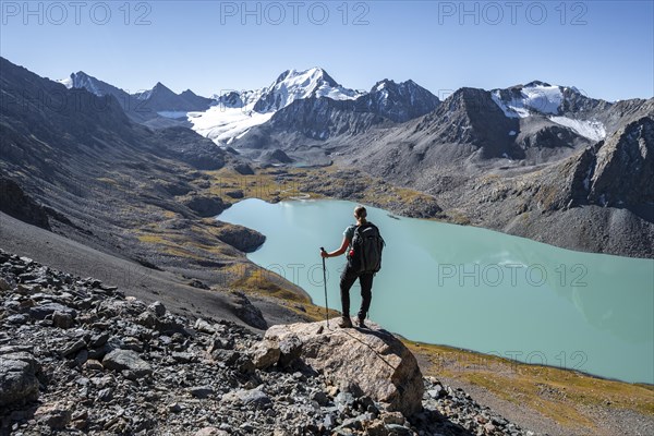 Trekking, hiker in the Tien Shan high mountains, mountain lake Ala-Kul Lake, 4000 metre peak with glacier, Ak-Su, Kyrgyzstan, Asia