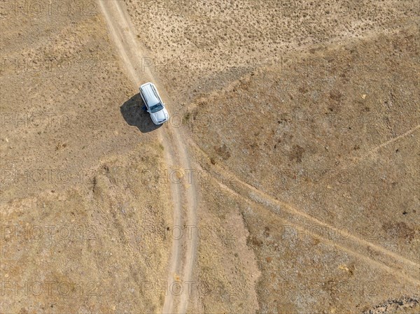 Aerial view, Vast empty landscape, Road and off-road vehicle, Top down view, Two paths divide, Symbolic for decisions, Moldo Too mountains, Naryn region, Kyrgyzstan, Asia