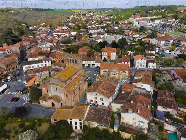 Aerial view of a small town with historic architecture and streets surrounded by landscape, parish church Eglise Saint-Pierre-et-Saint-Phebade, Venerque, Haute-Garonne, Occitania, France, Europe