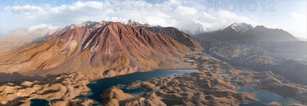 Atmospheric aerial view, high mountain landscape with glacier moraines and mountain lakes, behind Pik Lenin, Trans Alay Mountains, Pamir Mountains, Osher Province, Kyrgyzstan, Asia