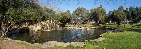 Waterfall and small pond, panoramic view, Fausto Noce Park, Olbia, Sardinia, Italy, Europe