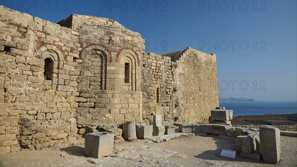 St John's Chapel, view of old walls with sea and mountains in the background in daylight, St John's Fortress, Lindos, Rhodes, Dodecanese, Greek Islands, Greece, Europe