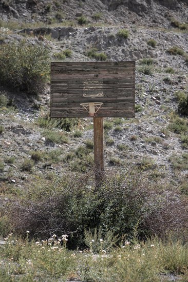 Abandoned basketball court, ghost town of Enilchek in the Tien Shan Mountains, Ak-Su, Kyrgyzstan, Asia