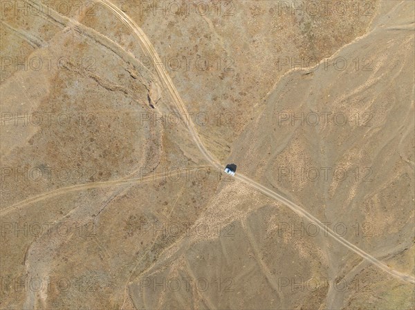 Aerial view, Vast empty landscape, Road and off-road vehicle, Top down view, Two paths divide, Symbolic for decisions, Moldo Too mountains, Naryn region, Kyrgyzstan, Asia