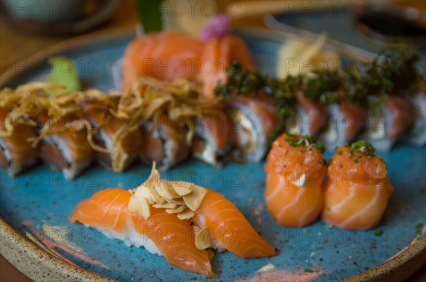 Combined of differents japanese sushi on a elegant blue plate