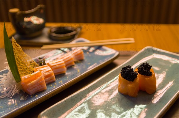 Combined of differents japanese sushi on a elegant blue plate