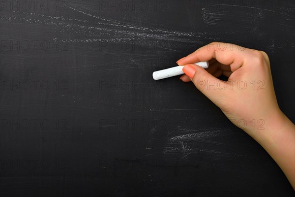 Woman's hand writing on chalkboard with piece of white chalk. KI generiert, generiert, AI generated