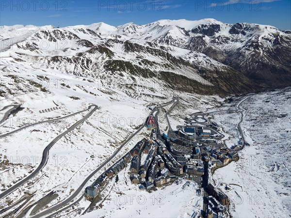 Aerial view of a ski resort with buildings and streets framed by snow-covered mountains, El Pas de la Casa, Encamp, Andorra, Pyrenees, Europe