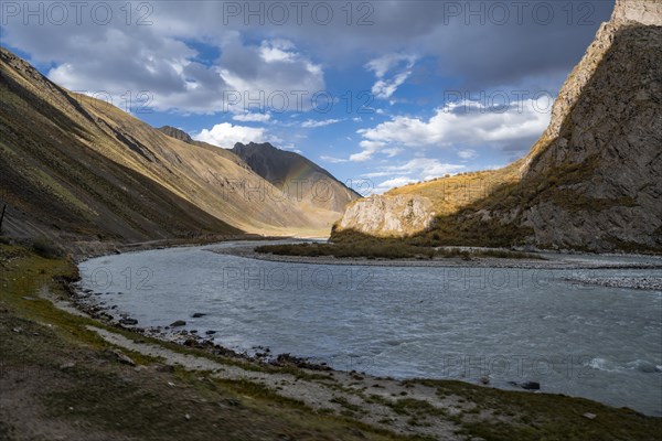 Mountain valley with Sary Jaz river and rainbow, autumn mountains with yellow grass, Tien Shan, Kyrgyzstan, Asia