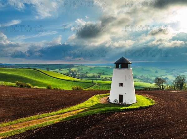 Sunset of Devon Windmill over Fields and Farms from a drone, Torquay, Devon, England, United Kingdom, Europe