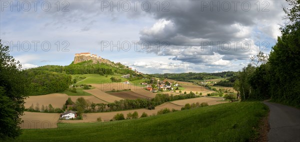 Field path leads to Riegersburg Castle in the evening light, field in front, panoramic view, cloudy mood, Riegersburg Castle, Styrian volcanic country, Styria, Austria, Europe