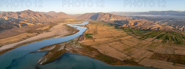 Naryn River between mountains and fields, at Toktogul Reservoir at sunset, aerial view, Kyrgyzstan, Asia