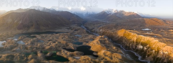 Atmospheric aerial view, high mountain landscape with glacier moraines and mountain lakes, behind Pik Lenin, Trans Alay Mountains, Pamir Mountains, Osher Province, Kyrgyzstan, Asia