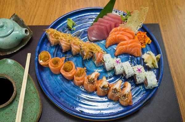 Combined of differents japanese sushi on a elegant blue plate