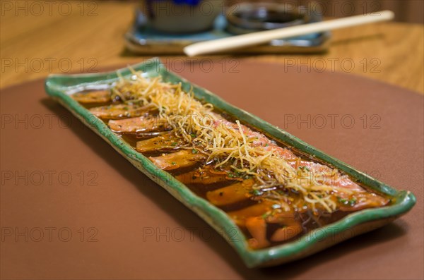 Delicious premium salmon sashimi arranged on an elegant handmade platter