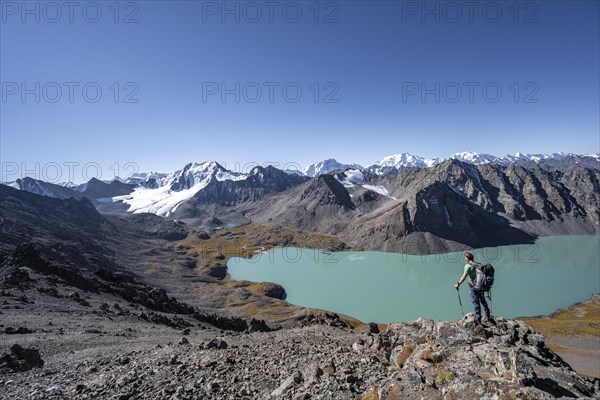 Mountaineers on the way to the Ala Kul Pass, view of mountains and glaciers and turquoise Ala Kul mountain lake, Tien Shan Mountains, Kyrgyzstan, Asia