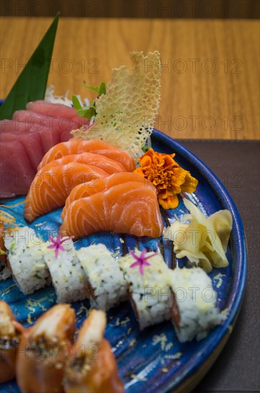 Combined of differents japanese sushi on a elegant blue plate