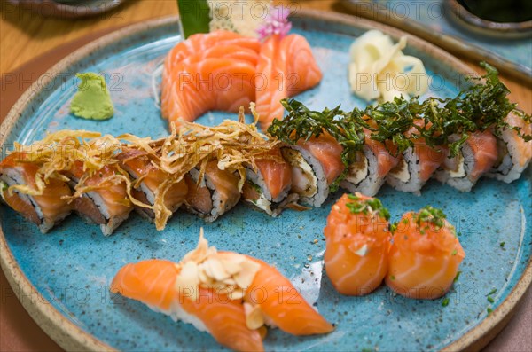 Combined of differents japanese sushi on a elegant blue plate