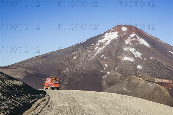 Campervan in front of the Lonquimay volcano, Lonquimay volcano, Malalcahuello National Reserve, Curacautin, Araucania, Chile, South America