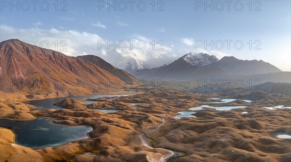 Atmospheric aerial view, high mountain landscape with glacier moraines and mountain lakes, behind Pik Lenin, Trans Alay Mountains, Pamir Mountains, Osher Province, Kyrgyzstan, Asia