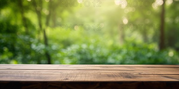 Wooden empty table with green forest in blurry background. KI generiert, generiert, AI generated