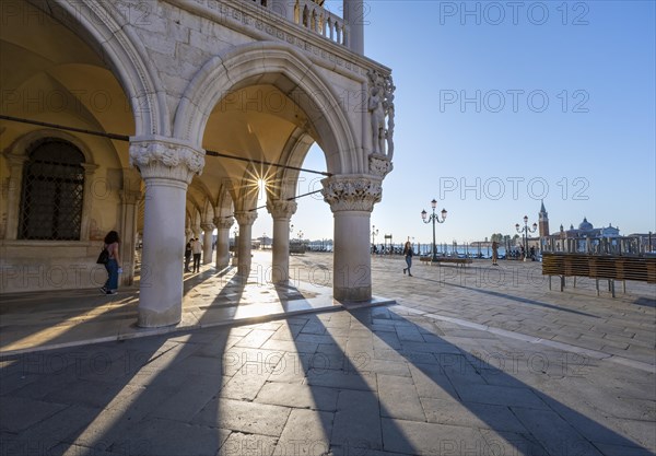 Colonnade of the Doge's Palace with Sun Star in the Piazetta San Marco, St Mark's Square, Venice, Veneto, Italy, Europe
