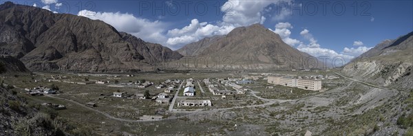 Town view, Abandoned buildings in barren landscape, Ghost town Enilchek in the Tien Shan Mountains, Ak-Su, Kyrgyzstan, Asia