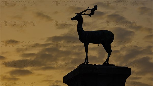 Silhouette of a Deer against the dramatic background of a sunset, twilight, Deer statue, Mandraki Oat, Rhodes, Dodecanese, Greek Islands, Greece, Europe