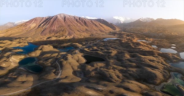 Atmospheric aerial view, high mountain landscape with glacier moraines and mountain lakes, behind Pik Lenin, Trans Alay Mountains, Pamir Mountains, Osher Province, Kyrgyzstan, Asia