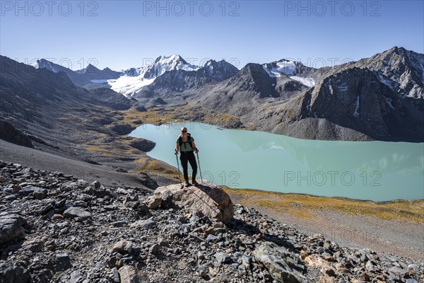 Trekking, hiker in the Tien Shan high mountains, mountain lake Ala-Kul Lake, 4000 metre peak with glacier, Ak-Su, Kyrgyzstan, Asia