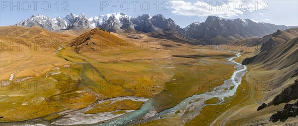 Aerial view, River Kol Suu winds through a mountain valley with hills covered with yellow grass, Pointed high mountain peaks with glaciers, Keltan Mountains, Sary Beles Mountains, Tien Shan, Naryn Province, Kyrgyzstan, Asia